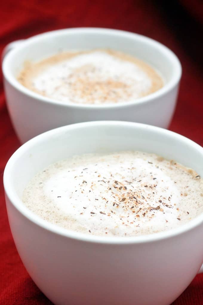 Two latte eggnog servings in white mugs.