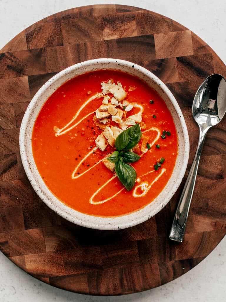 Tomato soup in a speckled bowl.