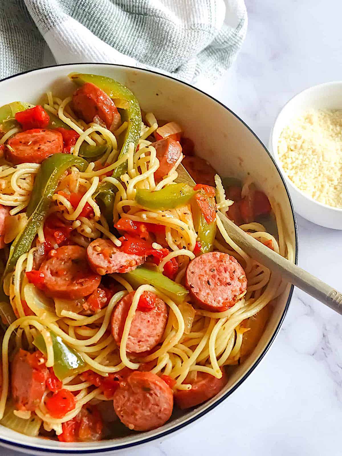 Kielbasa and pepper pasta with tomatoes in a pot.