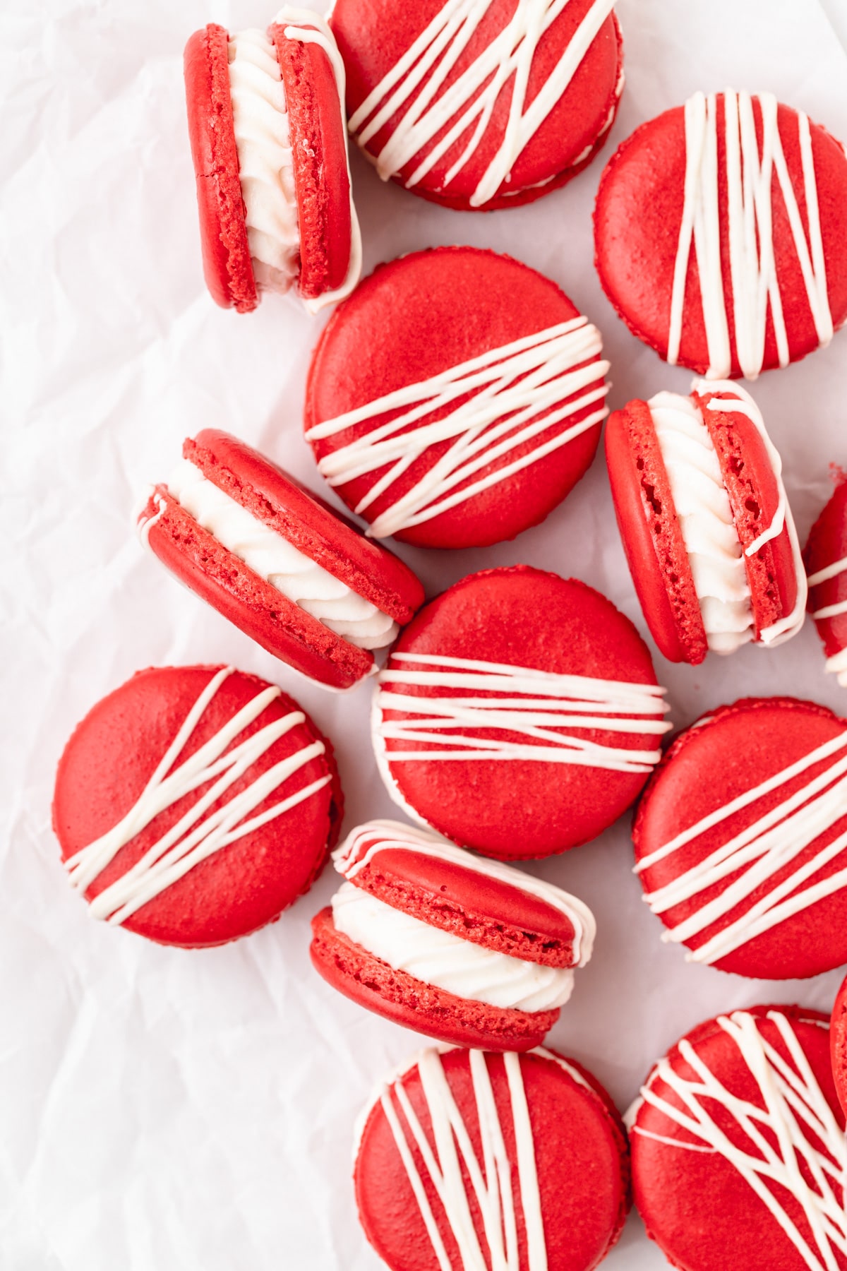 Red velvet macarons arranged on parchment paper.