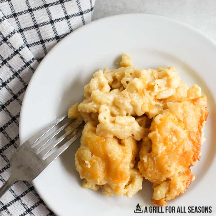 Smoked mac and cheese on a white plate with fork.