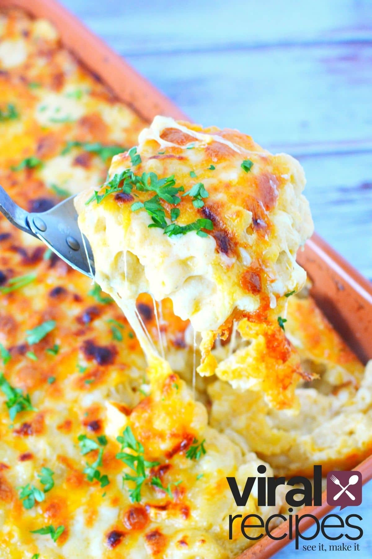 Scoop of mac in cheese pulled from casserole dish.