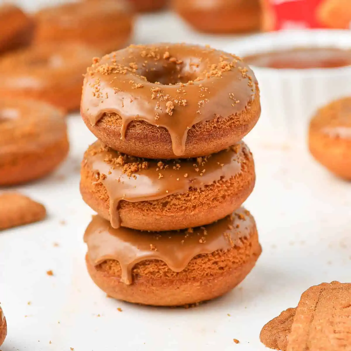 Stack of cookie butter dipped Biscoff donuts and sprinkled with Biscoff cookie crumbs.