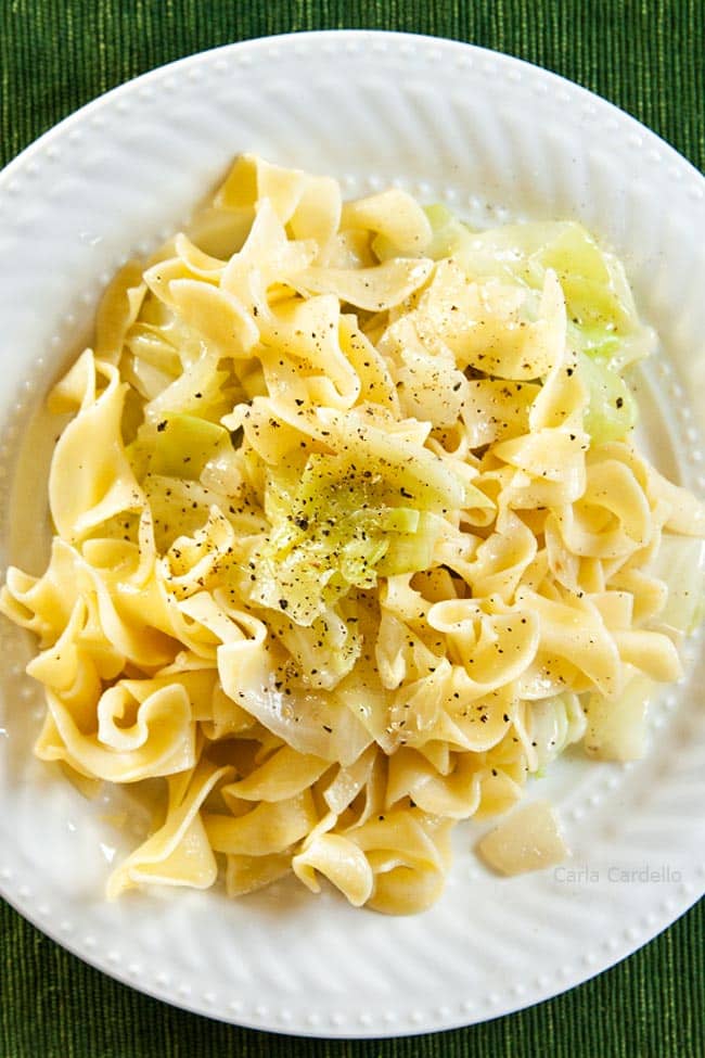 Egg noodle and cabbage dish (aka Haluski) on a white plate.