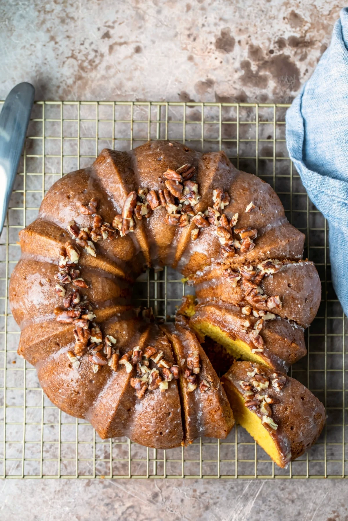 Irish cream bundt cake on cooling rack with slice pulled out.