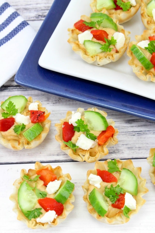 Roasted red pepper hummus phyllo cups arranged on a serving tray.