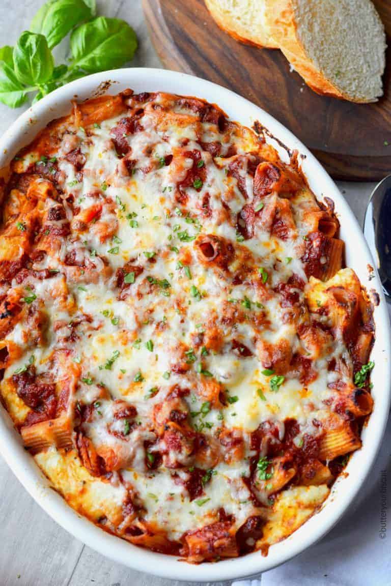 Baked ziti in a white casserole dish.