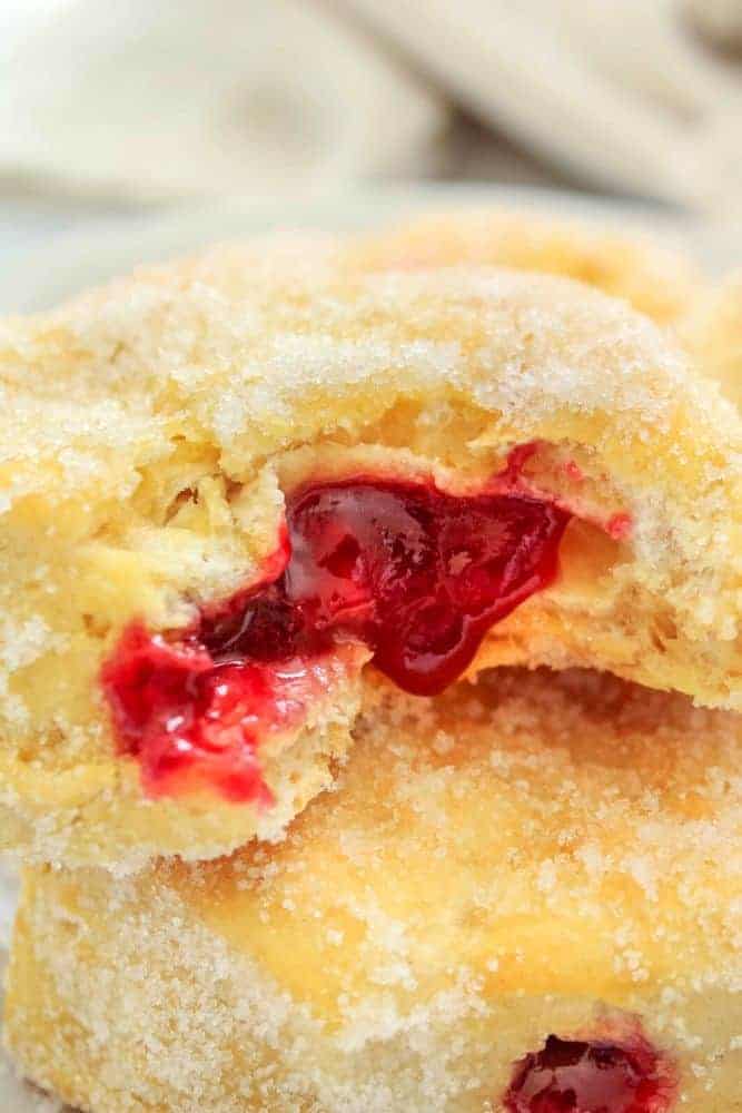 Air fryer donut with jelly oozing out.