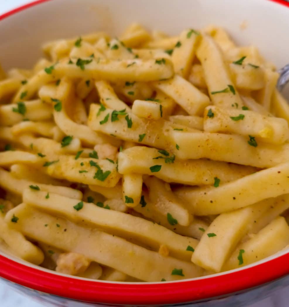 Amish brown butter noodles with parsley in a pot.