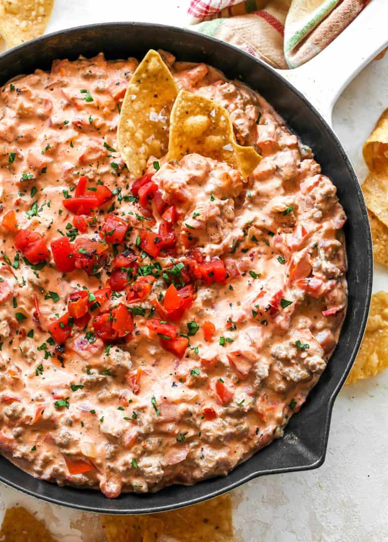 Cream cheese sausage dip in a skillet with corn chips.