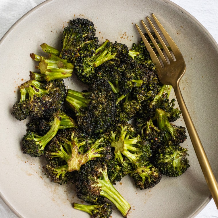 Air fryer balsamic garlic broccoli with a fork on a plate.