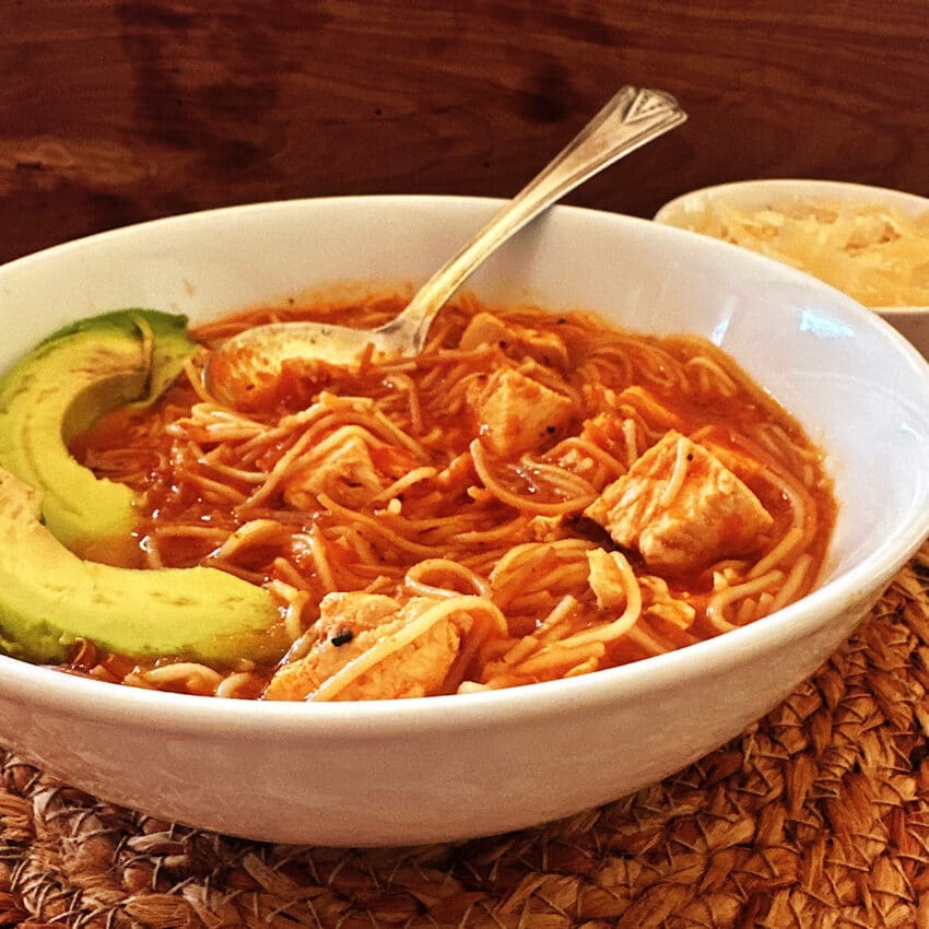 Mexican sopa de fideo in a white bowl.