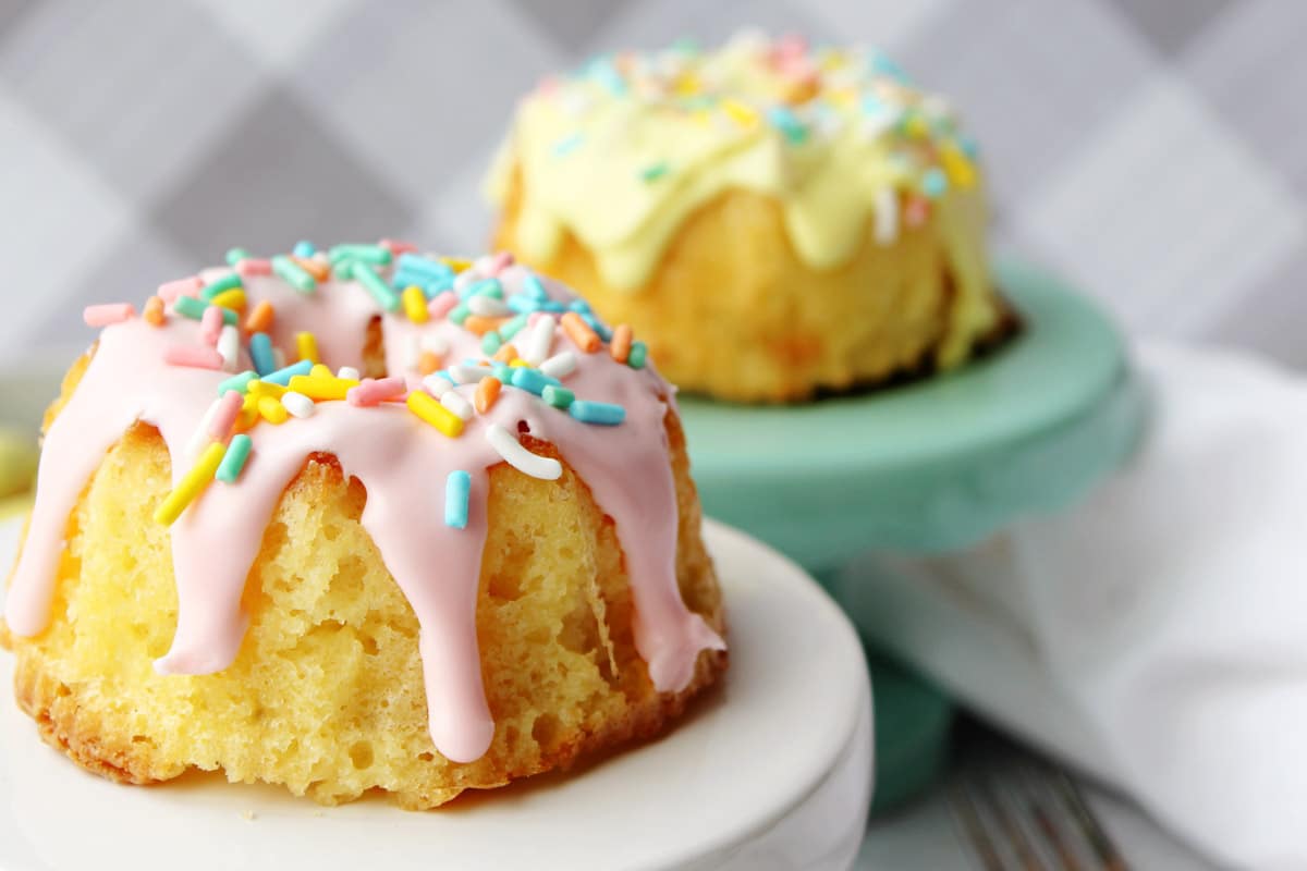 Springtime mini bundt cake with sprinkles on cake stands.