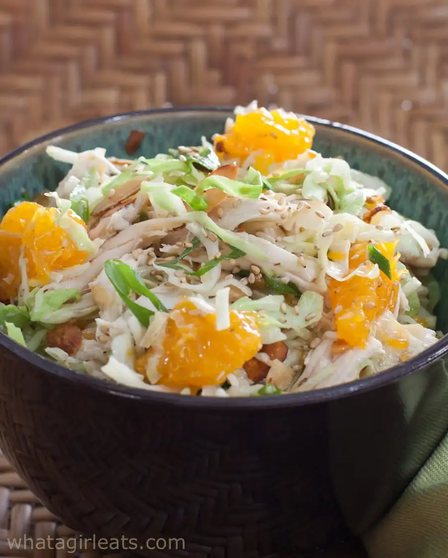 Chinese chicken salad in a bowl with chunks of mandarin oranges.