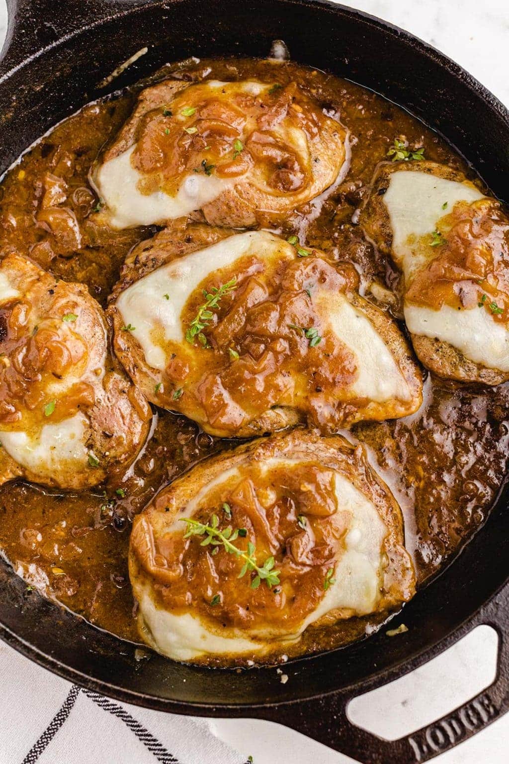 French onion pork chops in a cast iron pan.