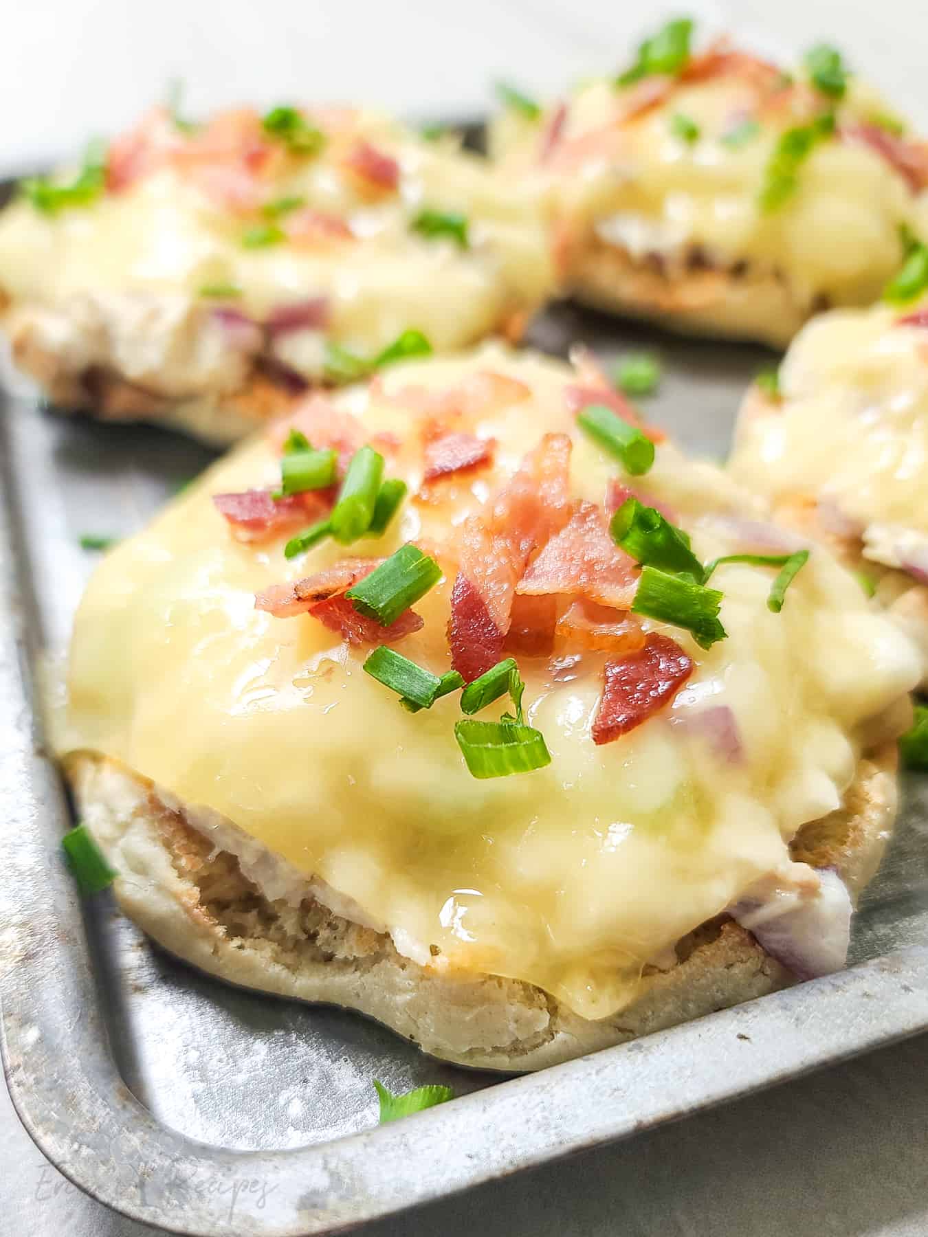 Tuna melt on english muffin with cheese, bacon, and chives.