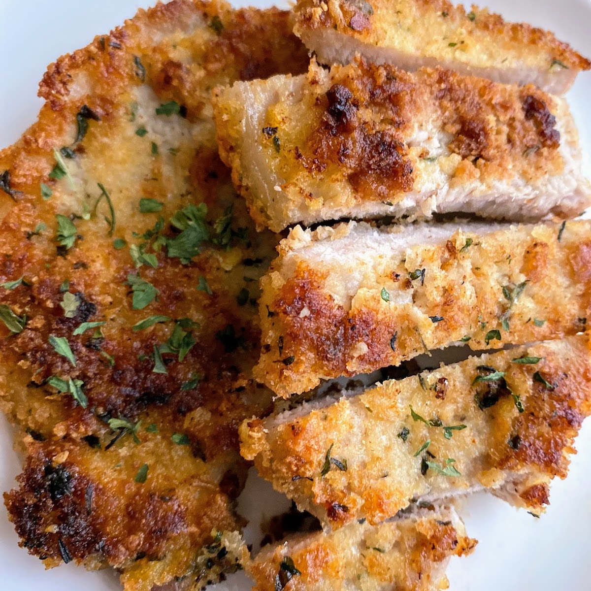 Crispy panko parmesan pork chops cut into pieces.