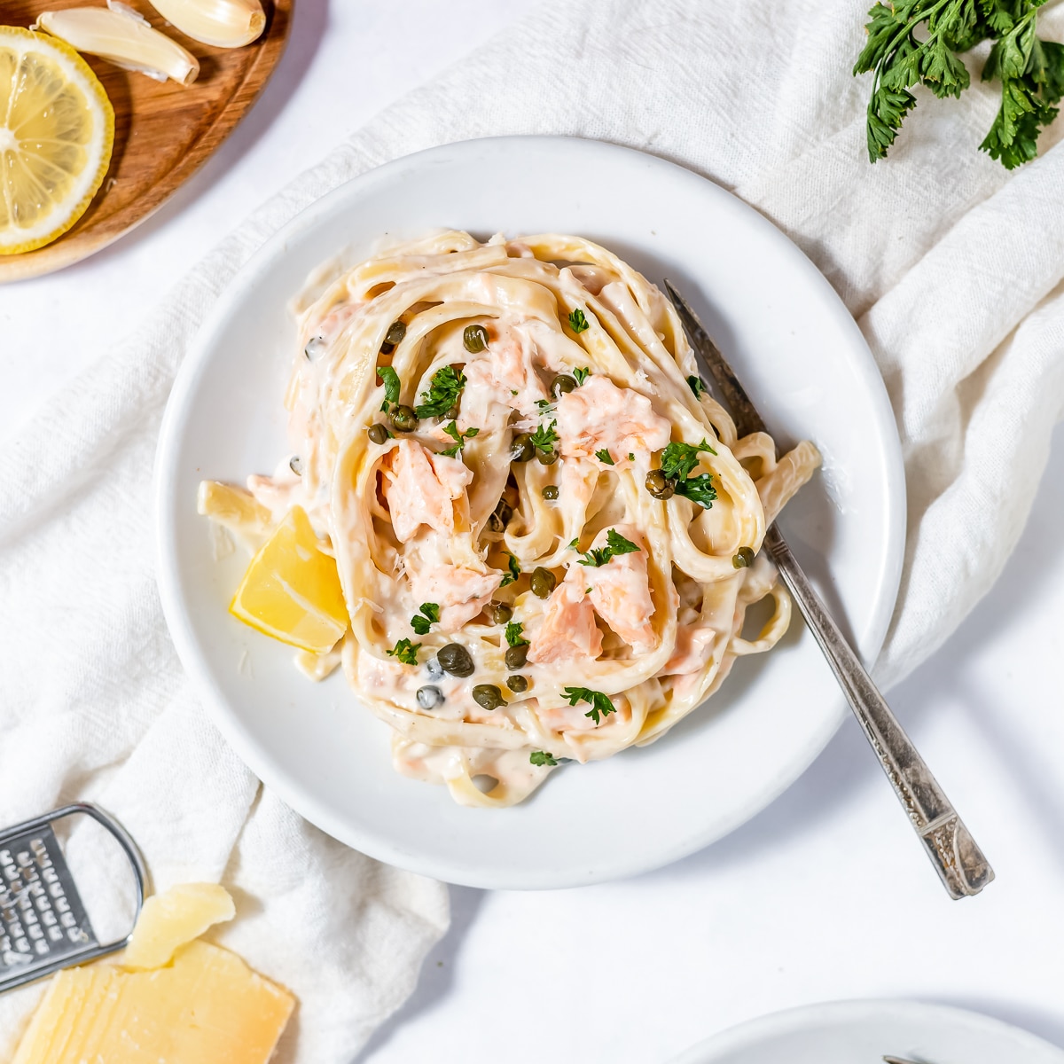 Mound salmon pasta on a white plate.