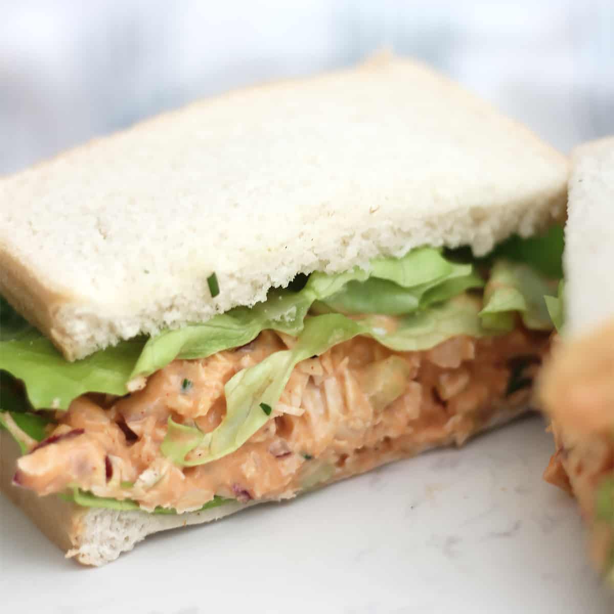 Buffalo tuna salad with lettuce on white bread.