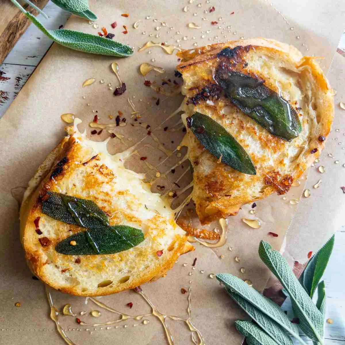 Grilled cheese with honey, sage, and butternut squash on parchment paper.