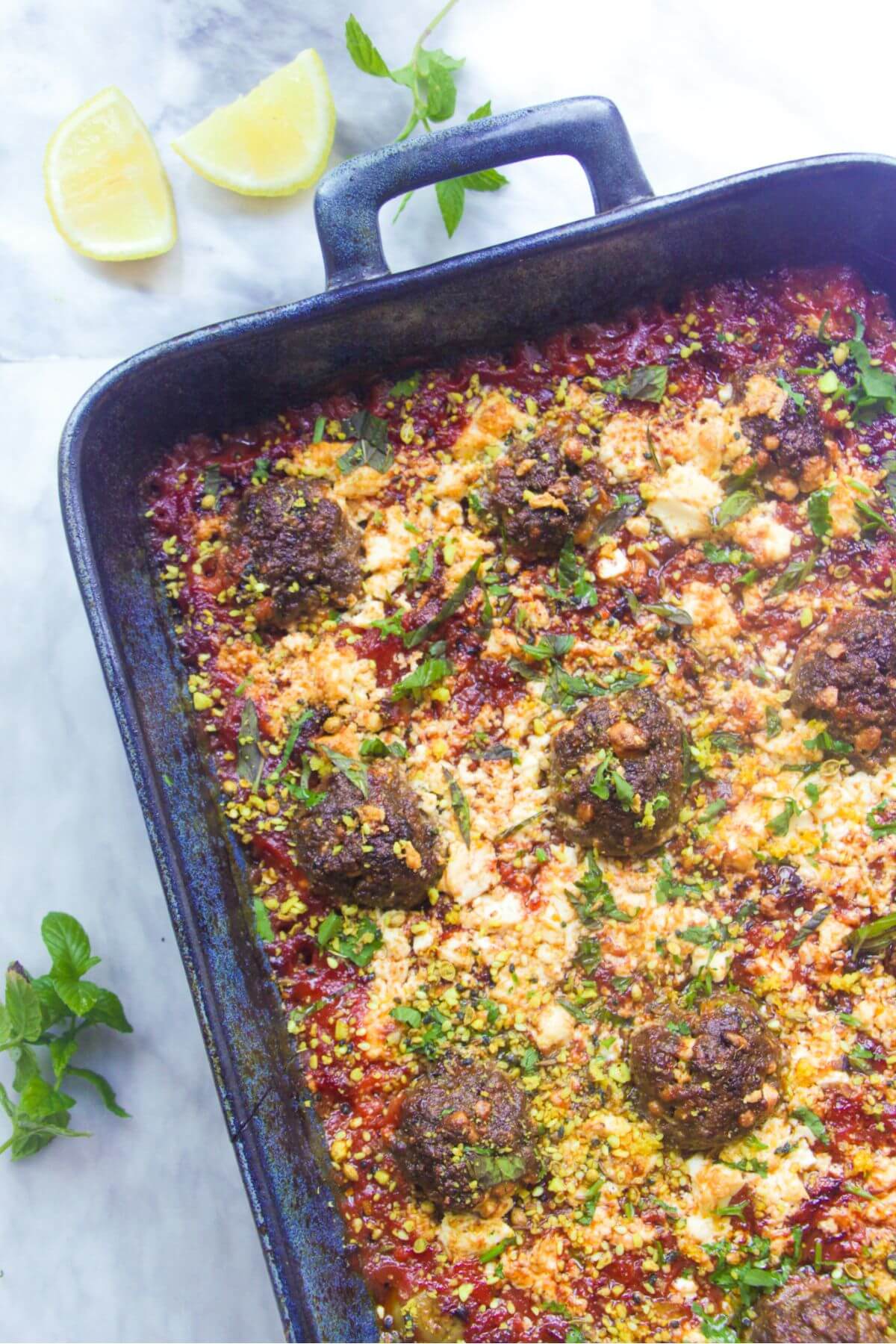 Greek lamb and feta meatball bake in a tray.