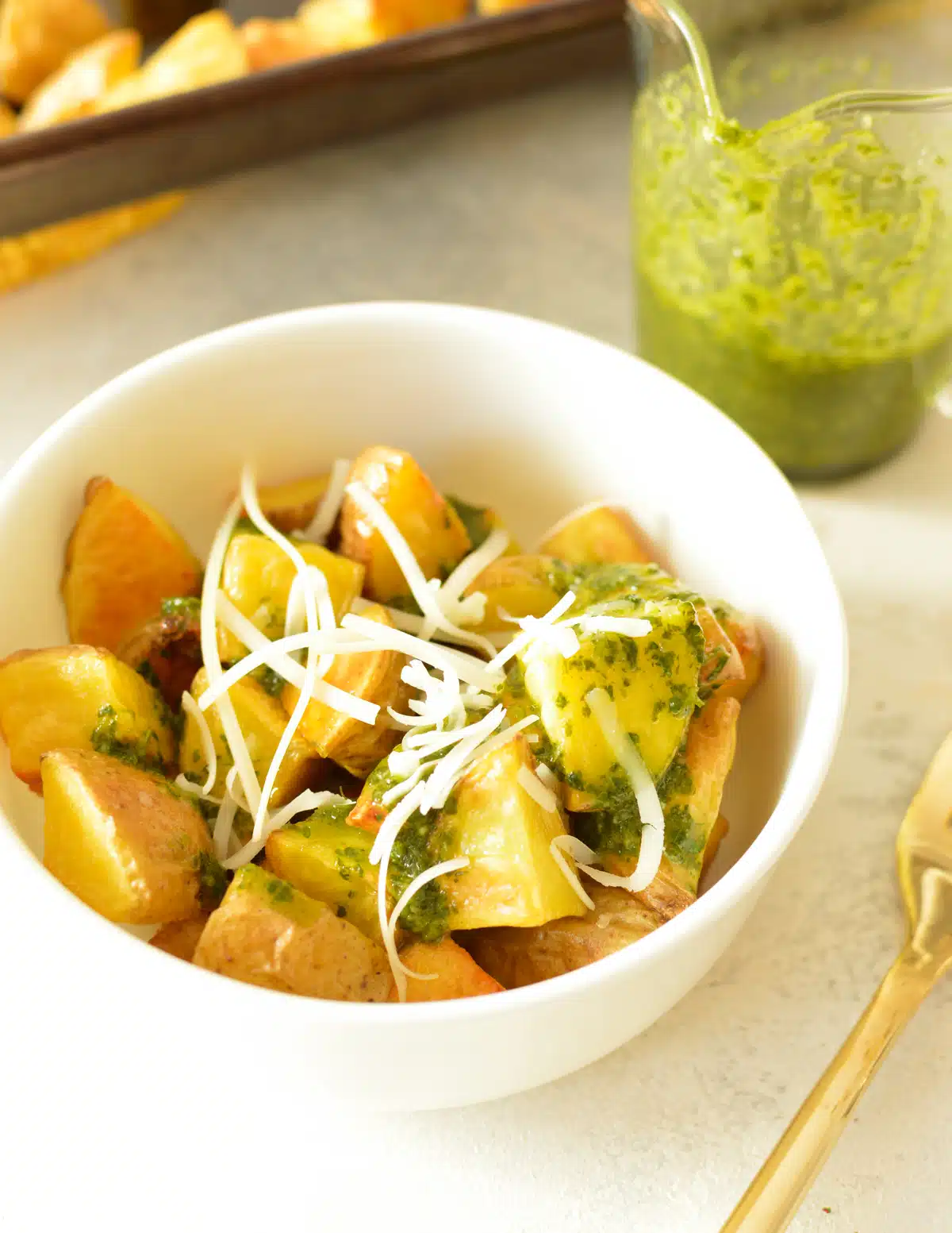 Roasted honey gold potatoes with cilantro vinaigrette. in a white bowl.