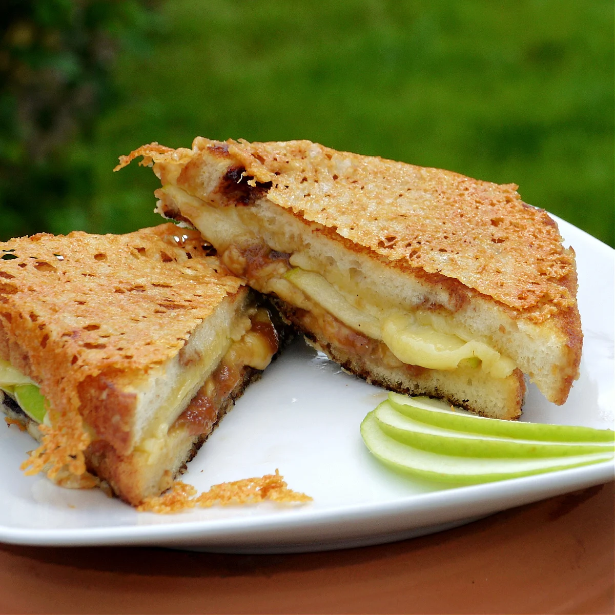 Irish apple pie cheese sandwich cut in half on a white plate.