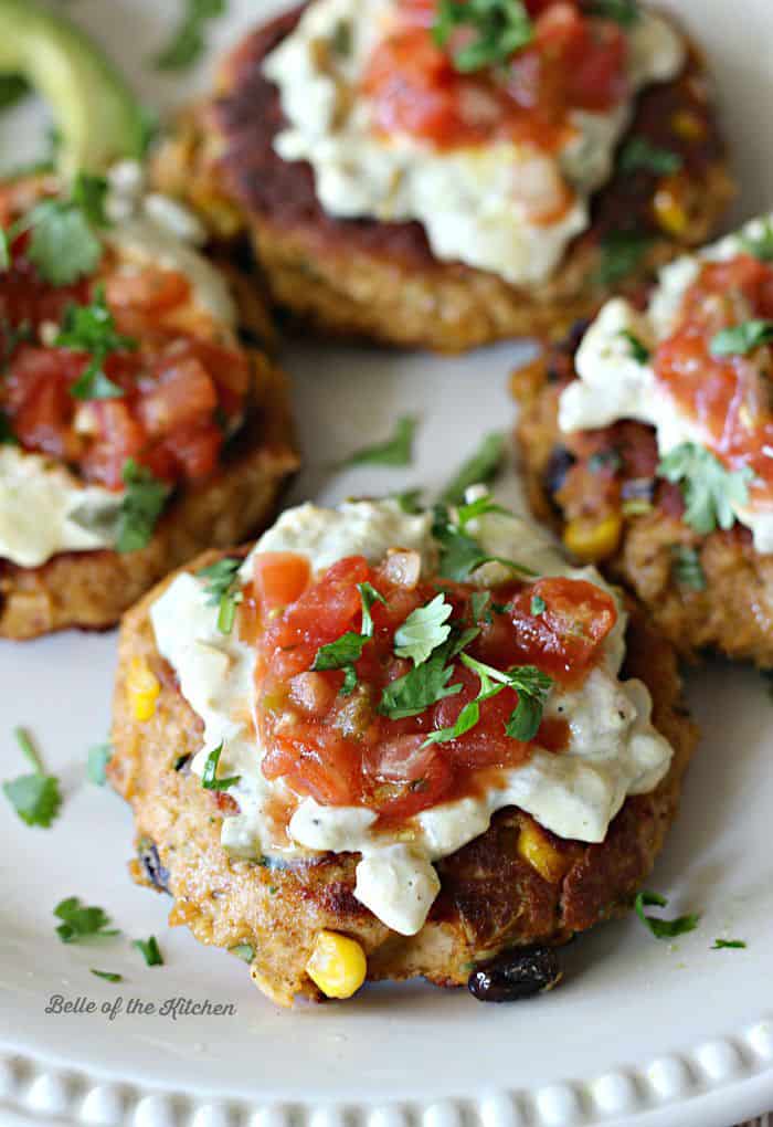 Mexican tuna cakes with jalapeno cream sauce on a white plate.