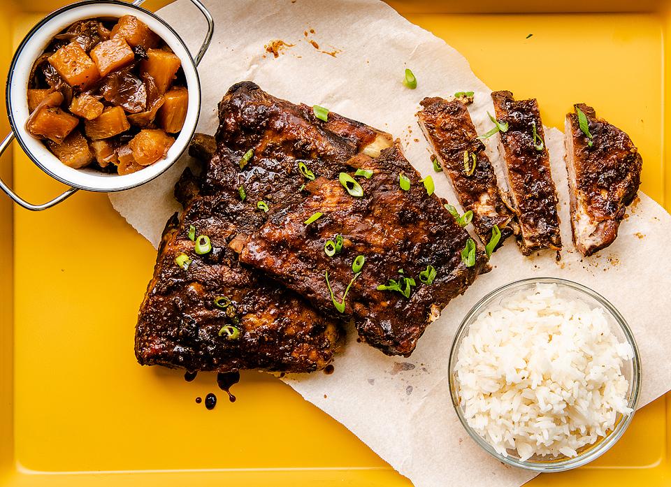 Slow cooker Hawaiian ribs on a yellow serving tray.