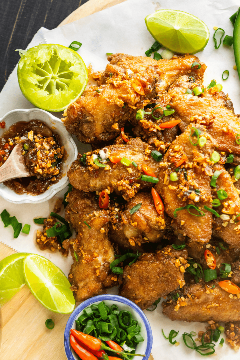 Fish sauce chicken wings on a parchment lined wooden serving tray.