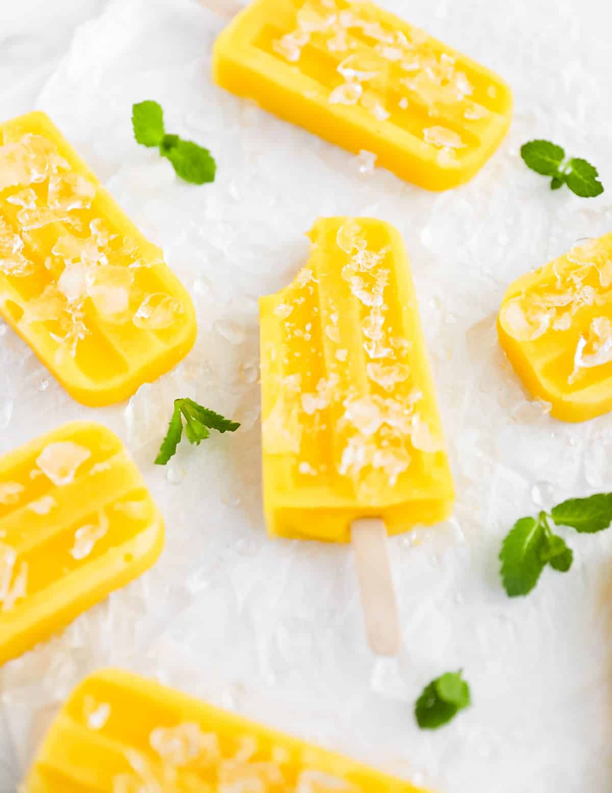 Mango popsicles arranged with ice.