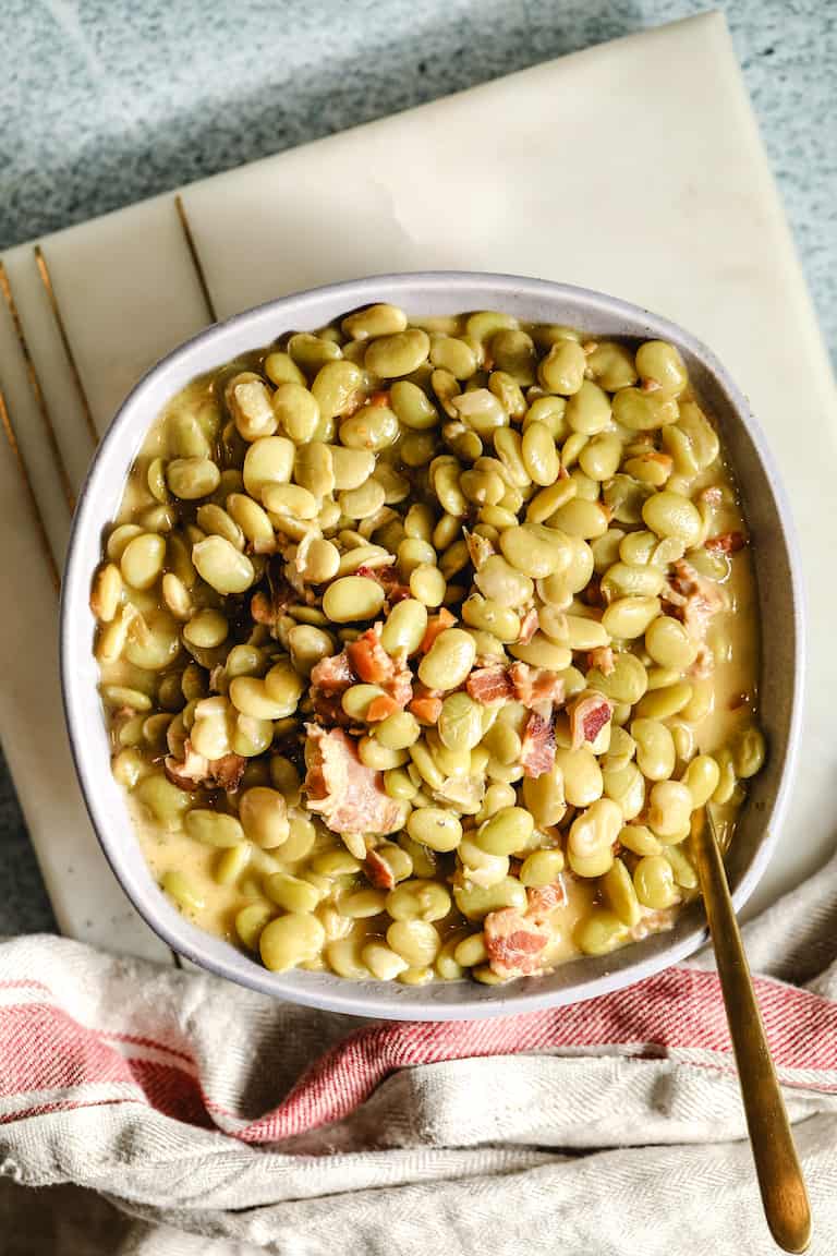 Southern butter beans with bacon in a serving dish.