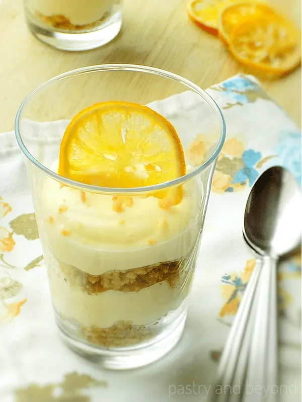 Lemon curd mousse in a glass dish with spoons.