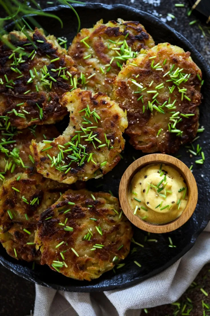 German potato cakes on a plate with chives and mustard.