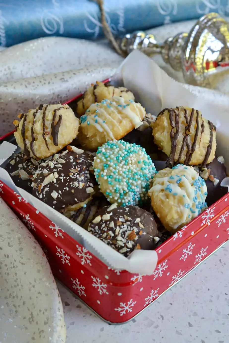 Assorted coconut macaroons in a decorative box.