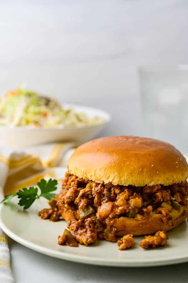 Sloppy Joes with ground turkey breast on a bun on a plate.