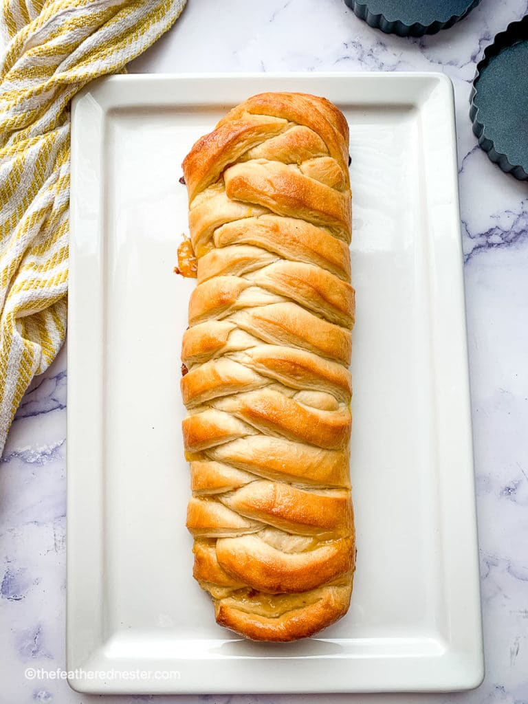 Lemon stuffed braided bread on a rectangle plate.