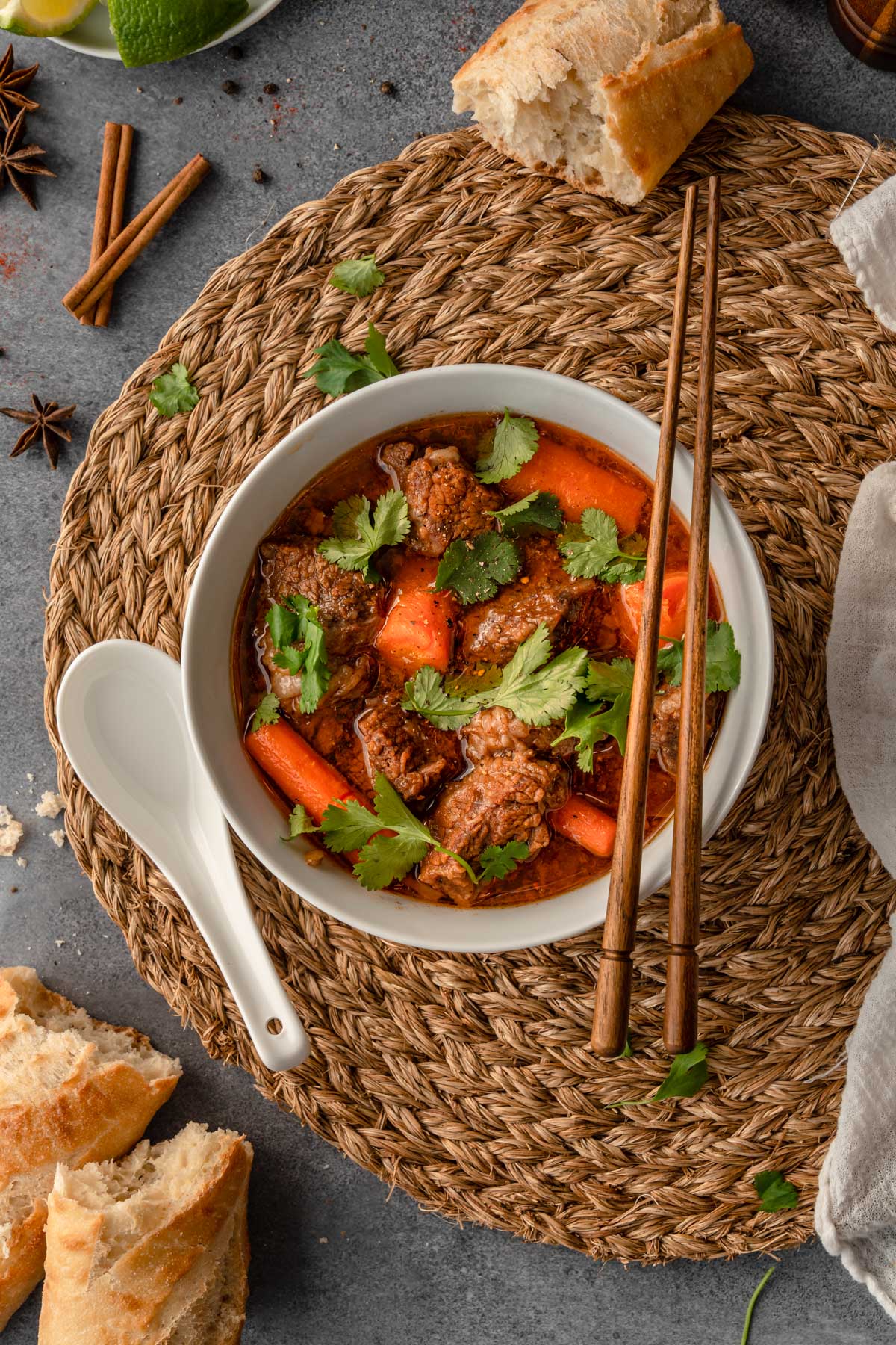 Instant pot bo kho or Vietnamese beef stew in a white bowl with chopsticks.