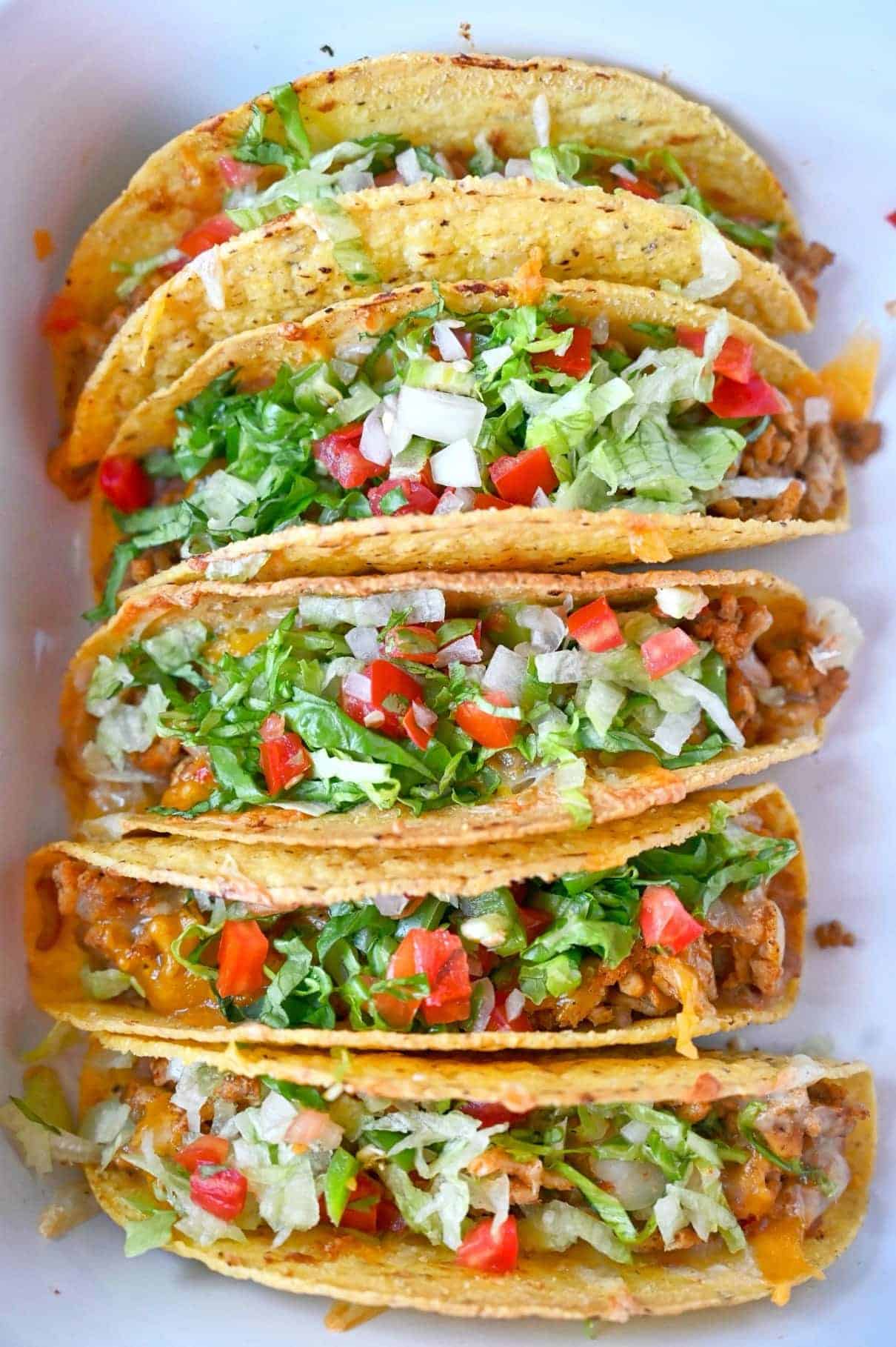 Baked chicken tacos lined up.