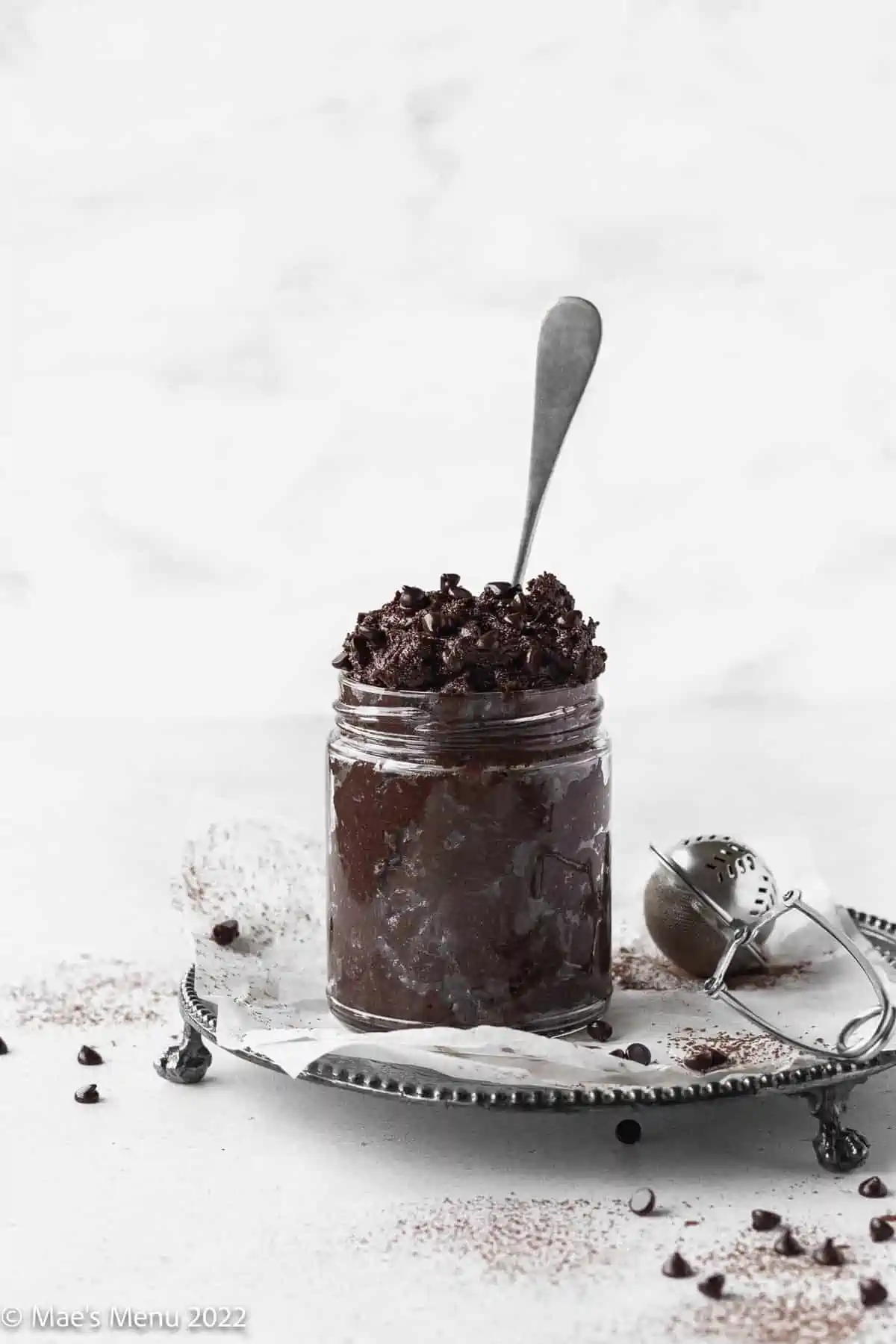 Edible brownie batter in a mason jar with spoon.