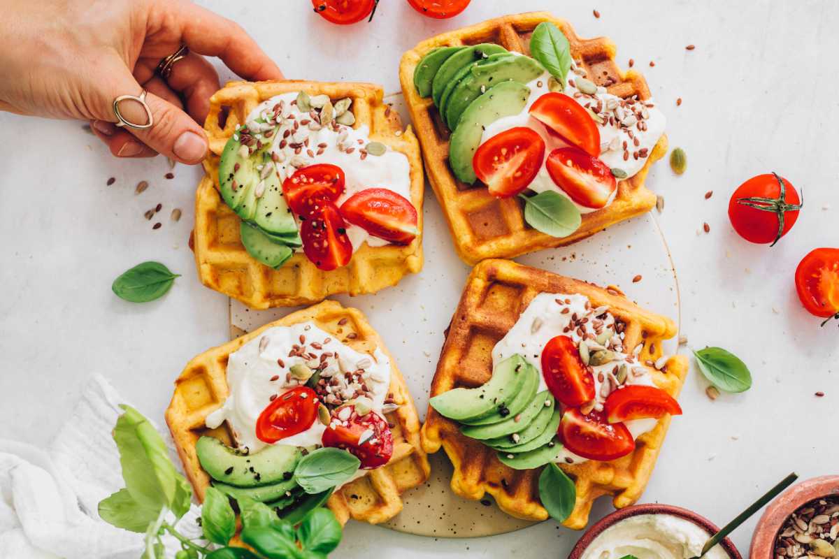 Vegan pumpkin waffles with tomatoes, avocado, and fresh basil.