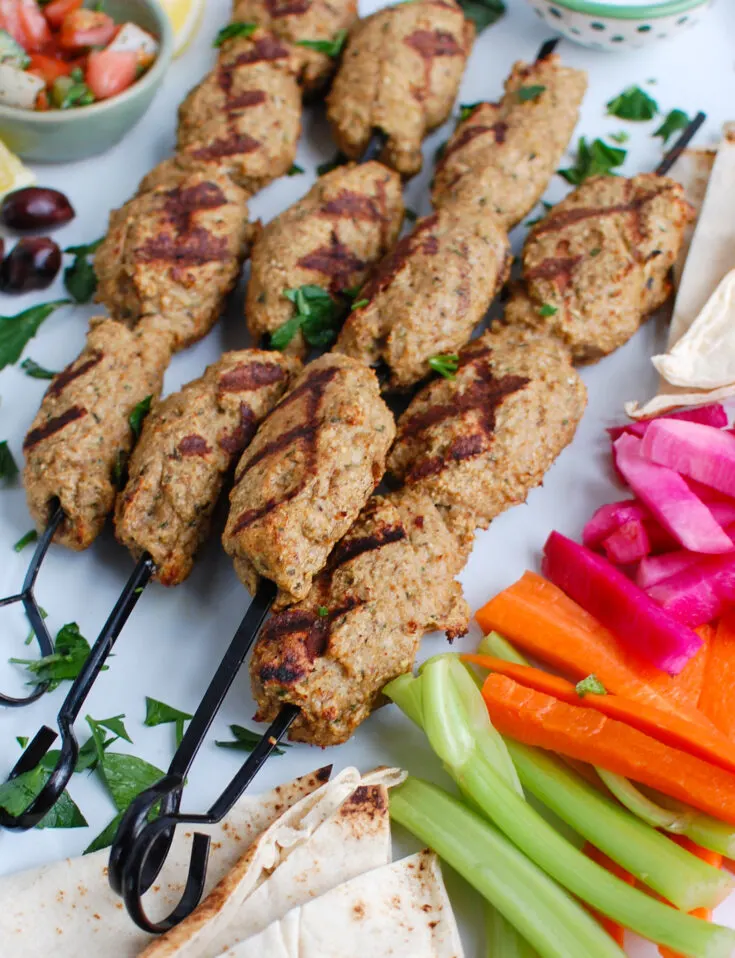 Chicken kofta on a skewer with veggies.