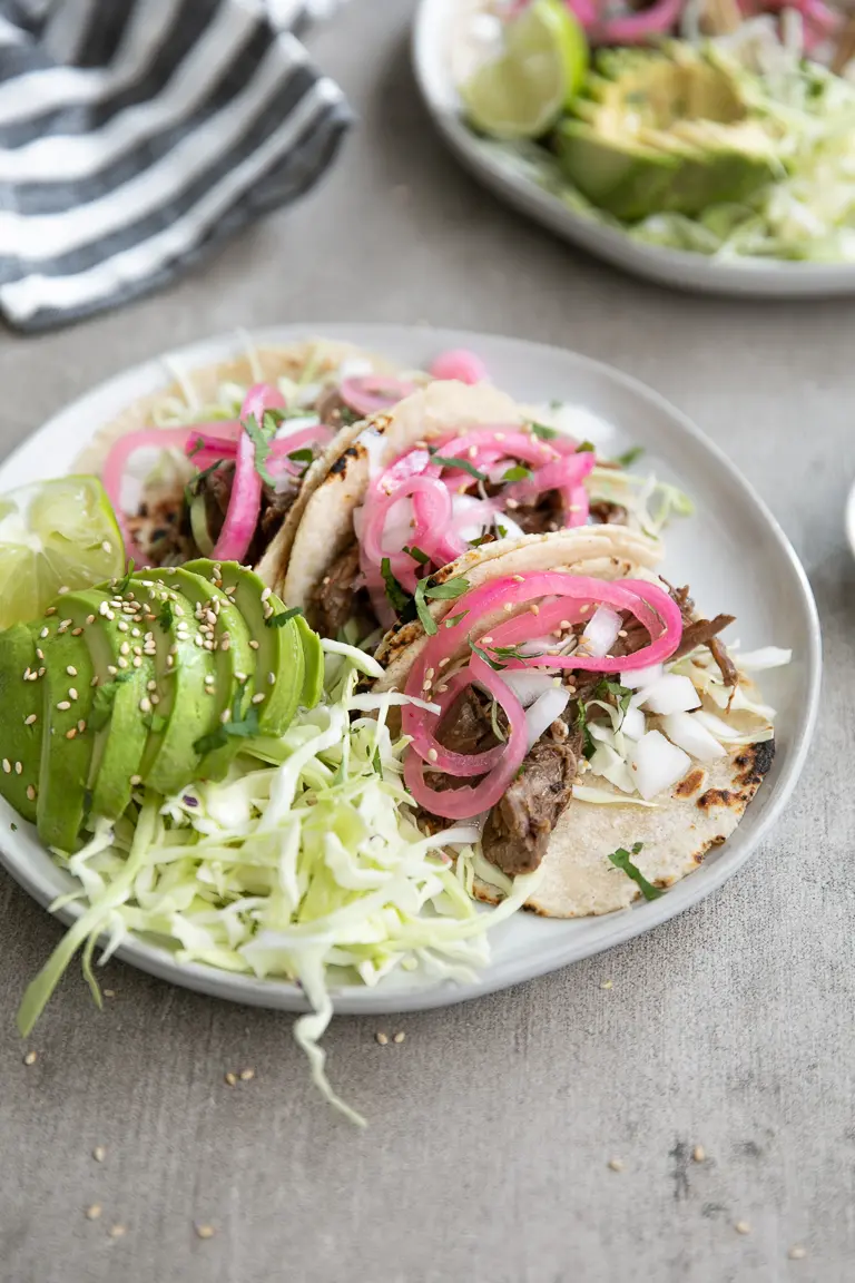 Lime teriyaki beef tacos on a plate.