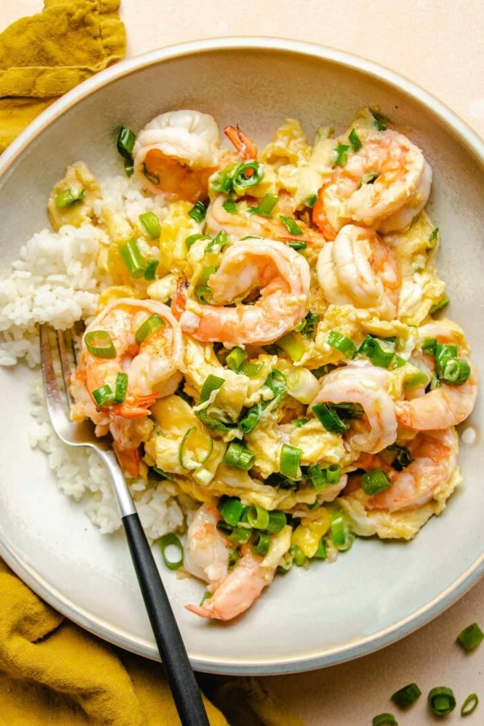 Shrimp scrambled eggs with rice on a plate.