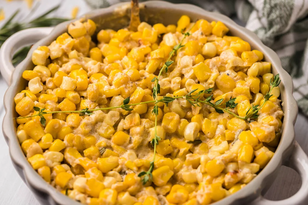Cheesy one pot cream cheese corn in a gray containers.