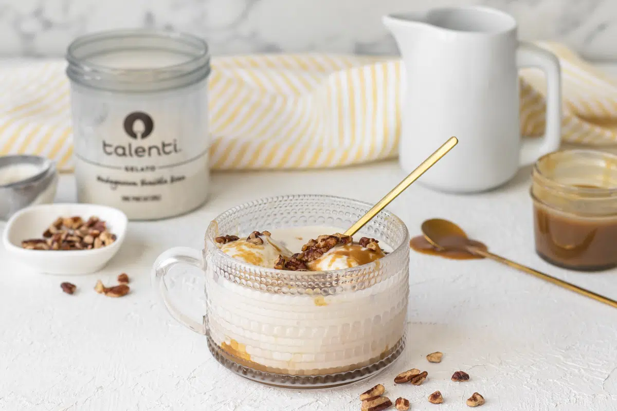 Caramel affogato in a clear glass mug.