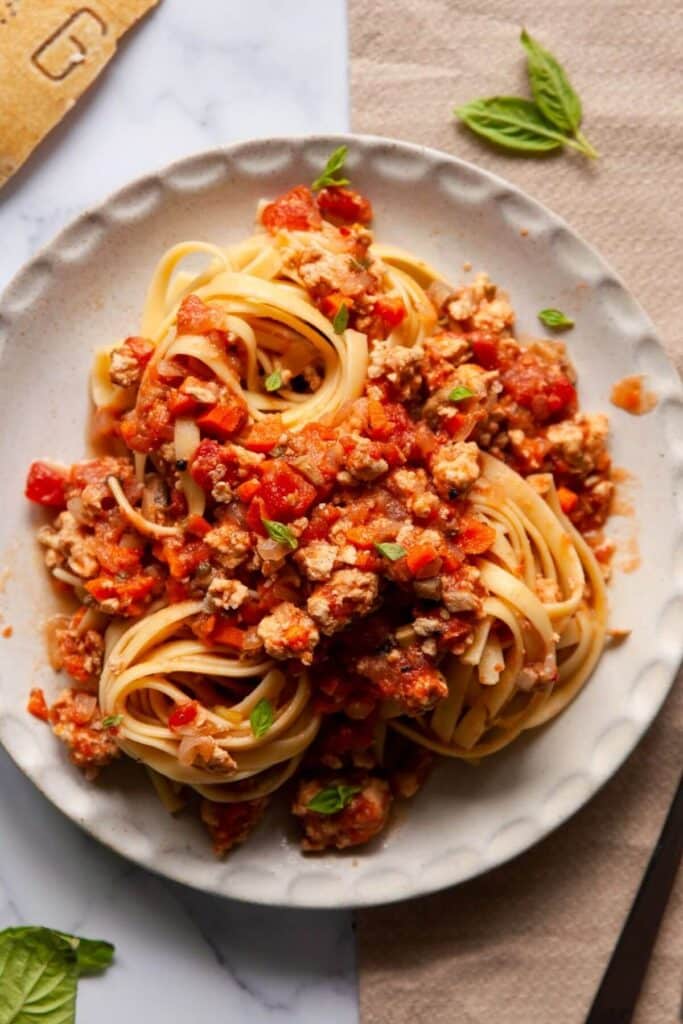 Chicken bolognese with pasta on a plate.