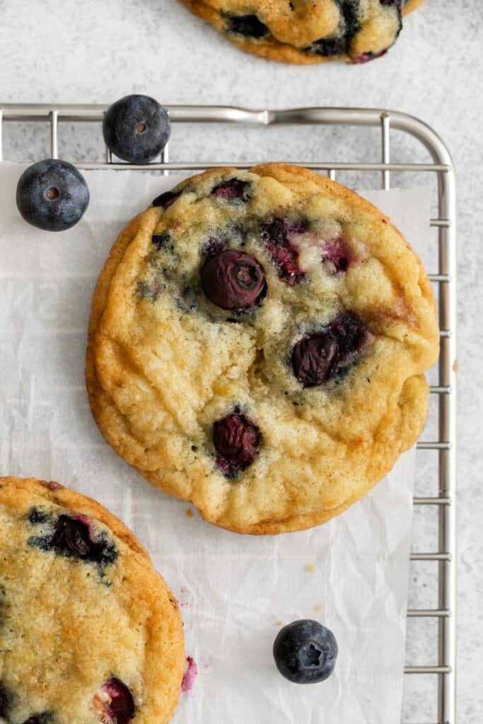 Lemon blueberry cookies on a cooling rack.