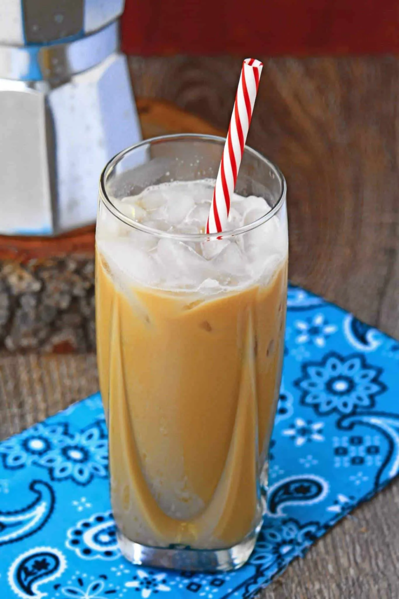 Vietnamese iced coffee with red and white straw.