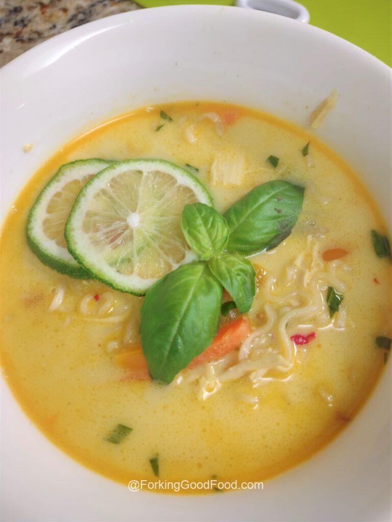 Easy Tom Kha Gai Thai coconut soup in a white bowl.